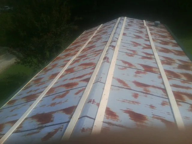 Rusted metal roof panels with new wood purlins before replacement — Storm Damage Roof Repair in Myrtle by Roofing Brothers